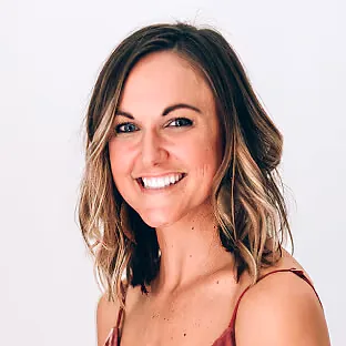 Small business owner smiling after QuickBooks bookkeeping success